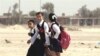 Students walk home from class in Tikrit, northwest of Baghdad. The lowest rate of primary enrollment in Iraq is among rural girls. (file photo)