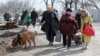 Ukrainian refugees leave the besieged city of Mariupol on March . 