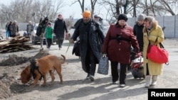 Ukrainian refugees leave the besieged city of Mariupol on March . 
