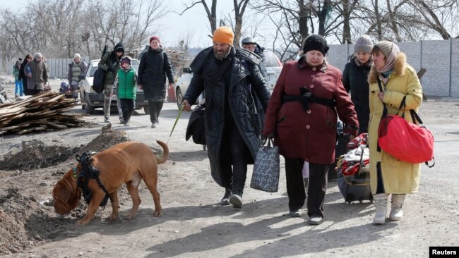 Ukrainian refugees leave the besieged city of Mariupol on March . 