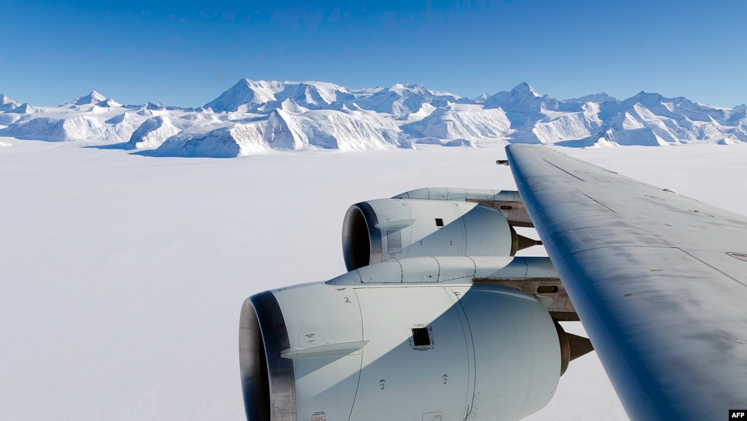 A NASA photo shows the wing of a DC-8 as it flies past Antarctica's tallest peak, Mount Vinson, during research on polar warming in 2012.