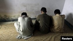 Children whose families say they have been abused turn their backs to the camera as they are interviewed in their village of Husain Khan Wala, Punjab, in August 2015.