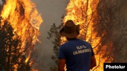 Armenia - A Ministry for Emergency Situations worker battles a wildfire in the Vayots Dzor province, 11Aug2017.