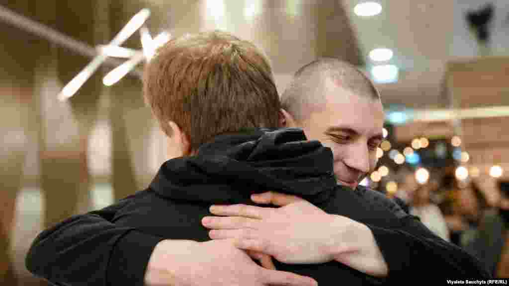 Ihar Losik (right), a Belarusian journalist with RFE/RL, embraces his brother Mikita in Vilnius, Lithuania, on September 11 after Ihar's release from Belarusian captivity. Ihar served more than five years of a 15 year sentence on politically motivated charges. Losik arrived in Lithuania with 50 others following a thaw in US-Belarus relations aided by diplomatic efforts from the US and Lithuania.Photo by Viyaleta Sauchyts/RFE/RL's Belarus Service.