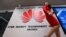 File photo: Belgium - A woman walks past a logo at the entrance of the European Huawei Cyber Security Transparency Centre during its opening in Brussels on March 5, 2019.