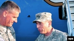 Newly appointed ISAF commander, General David Petraeus (right), talks with Lieutenant General David Rodriguez upon his arrival in Kabul on July 2.