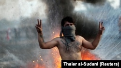 An Iraqi demonstrator gestures during ongoing anti-government protests in Baghdad.