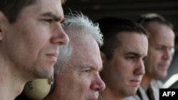U.S. Secretary of Defense Robert Gates, 2nd from left, watches flight operations aboard the USS Abraham Lincoln in the Arabian Sea on December 6, 2010.