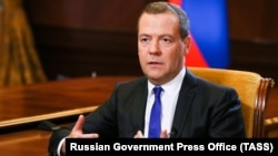 Russian Prime Minister Dmitry Medvedev speaks during an interview with Kommersant at the Gorki state residence outside Moscow on August 7.