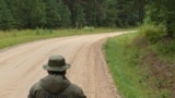 A Russian border guard looks towards his Estonian counterpart inside the "Saatse Boot" section of the two countries' shared border. 