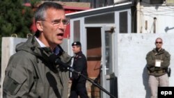 NATO Secretary-General Jens Stoltenberg talks with Italian NATO forces officials in Herat, Afghanistan on November 7, 2014.