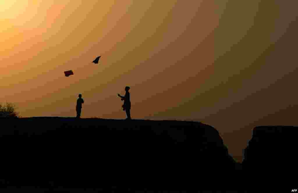 Afghan youths play with a kite on the outskirts of Jalalabad on October 18. (AFP/Noorullah Shirzada)