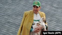 Turkmen President Gurbanguly Berdymukhammedov holds an alabai puppy as he takes part in celebrations for the Day of the Horse in Ashgabat in 2018.