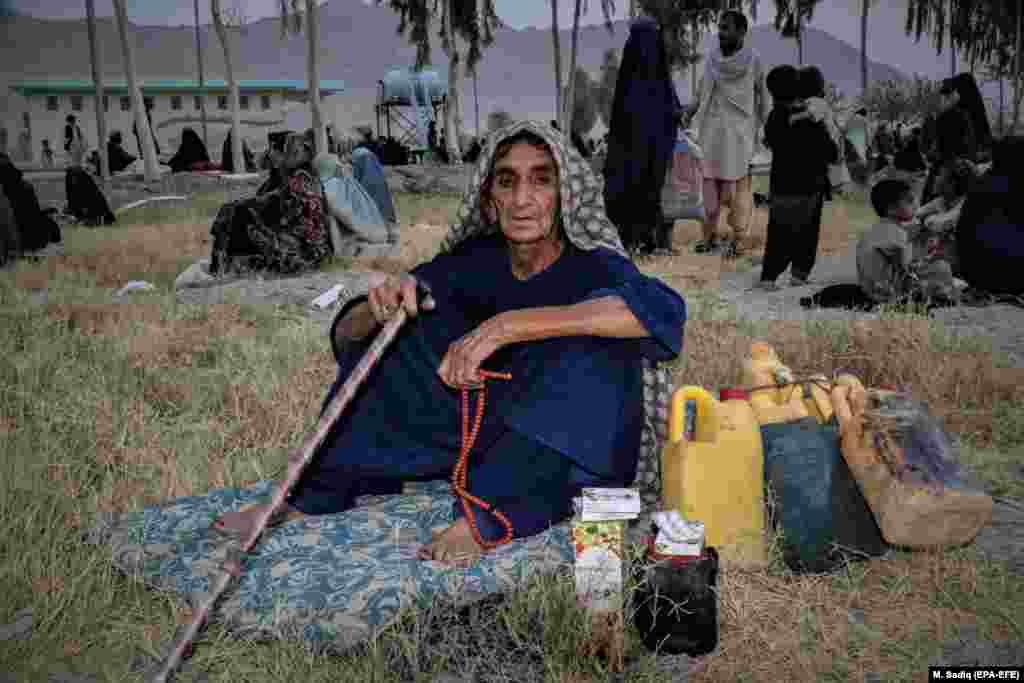 Families displaced from districts with fighting between Afghan security forces and the Taliban wait for relief in temporary shelters in Kandahar.