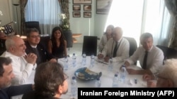 French President Emmanuel Macron and French French Foreign Affairs Minister Jean-Yves Le Drian meets with Iranian Foreign Minister Mohammad Javad Zarif (2ndL) during a meeting in the city hall of Biarritz, August 25, 2019