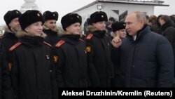 Russian President Vladimir Putin (right) meeting with military cadets last month.