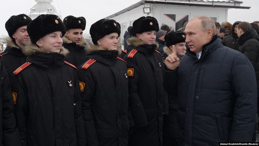 Russian President Vladimir Putin (right) meeting with military cadets last month.