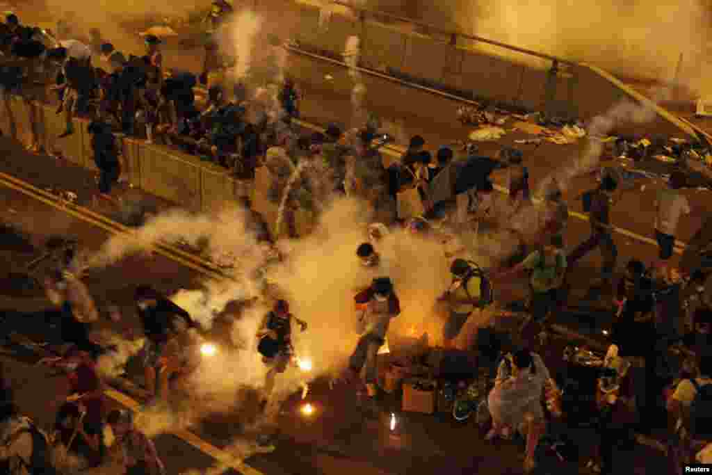 Riot police fire teargas to disperse protesters after thousands of demonstrators blocked the main street to the central financial district outside the government headquarters in Hong Kong on September 29. (Reuters) 