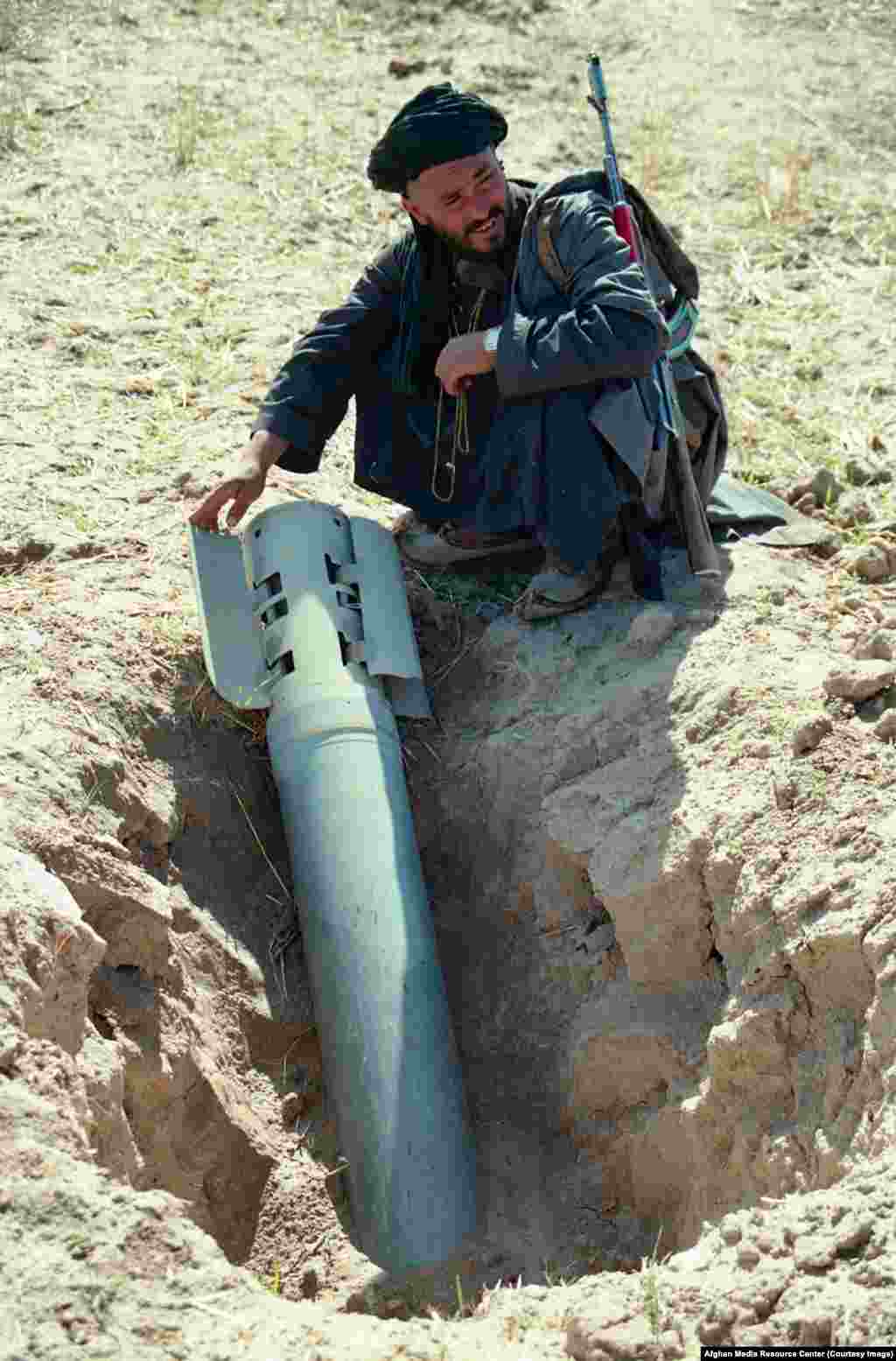 A mujahedin fighter with an unexploded Soviet rocket. When the AMRC archive was handed to the U.S. Library of Congress in 2016, a speaker noted the images filled "a huge gap" in the visual record of the Soviet Union's last war.
