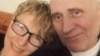 A picture released on February 19 shows Belarusian opposition figure Mikalay Statkevich (right) and his wife, Marina Adamovich, at their home in Minsk following his release.