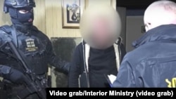 შინაგან საქმეთა სამინისტროს მიერ გავრცელებული ვიდეოს კადრი - ერთ-ერთ დაკავებულს სამართალდამცავი აცნობს მის მიმართ წარდგენილ ბრალს, 3 თებერვალი, 2026 წელი