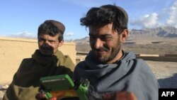 Dutch soldiers gave a radio to these villagers in Afghanistan's southern Uruzgan Province in January.