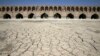 In this Tuesday, July 10, 2018 photo, the Zayandeh Roud river no longer runs under the 400-year-old Si-o-seh Pol bridge, named for its 33 arches, in Isfahan, Iran. 