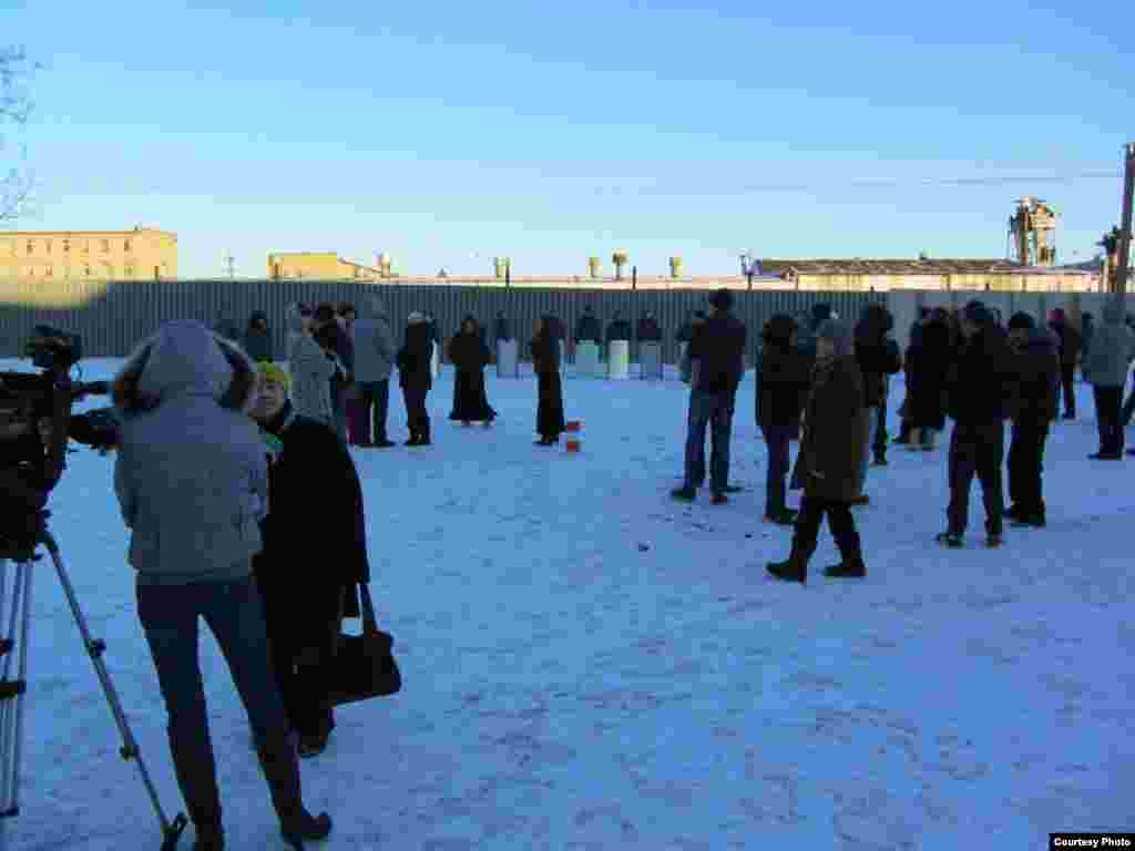 Media, relatives, and friends of inmates gather in front of the prison.