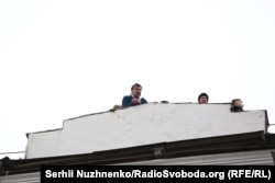 Saakashvili speaks from the roof of his apartment building before being detained.