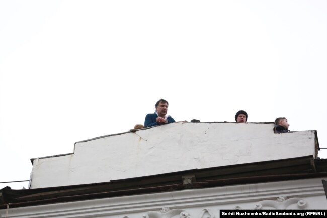 Saakashvili speaks from the roof of his apartment building before being detained.