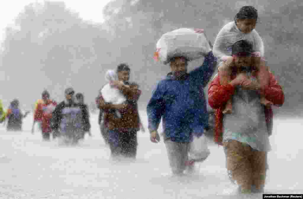 Residents wade through floodwaters from Tropical Storm Harvey in Beaumont Place, Houston, Texas. Houston officials announced a curfew on the flood-stricken city late on August 29 to prevent looting in evacuated areas as the deluge of rain from Tropical Storm Harvey set a new record for the continental United States. (Reuters/Jonathan Bachman)