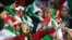 Iranian women cheer during the World Cup Qatar 2022 Group C qualification football match between Iran and Cambodia at the Azadi stadium in the capital Tehran on October 10, 2019. 
