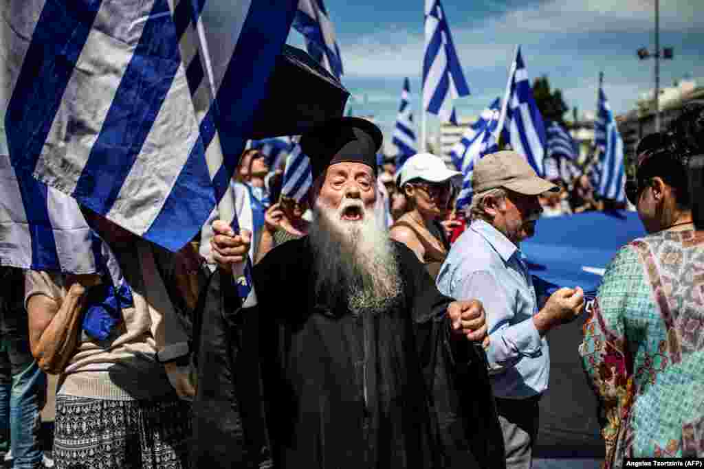 A Greek Orthodox priest takes part in a demonstration against the agreement reached to resolve a 27-year name dispute with Macedonia in Athens on June 15. (AFP/Angelos Tzortzinis)
