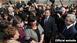 Armenian President Serzh Sarkisian (far right) talks to residents of the village of Akhuryan during a working visit on April 7, a month before national elections.