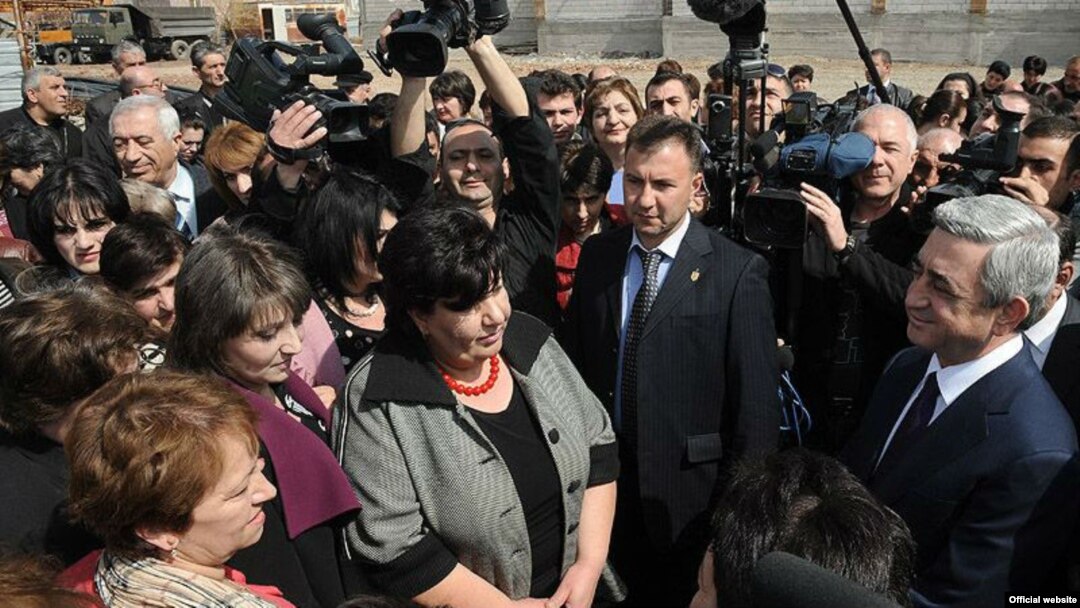 Armenian President Serzh Sarkisian (far right) talks to residents of the village of Akhuryan during a working visit on April 7, a month before national elections.