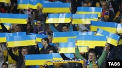 Red-carded: Ukrainian soccer fans cheer during a 2014 World Cup qualifying soccer match between Ukraine and England in Kyiv on September 10.