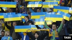 Ukrainian soccer fans cheer during the 2014 World Cup qualifying soccer match between Ukraine and England in Kyiv on September 10.