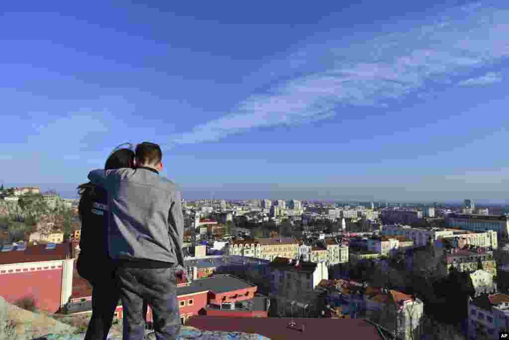 A couple takes in a view of Plovdiv, the first Bulgarian city to become a European Capital of Culture. The EU initiative is intended to celebrate the diversity of cultures in Europe, boost tourism, and support the cultural life of the selected cities. 