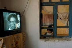 A girl watches a Soviet-era film in a Romany village near Bukhara. The village is one of Anzor’s favorite places to photograph after he was accepted into the community several years ago.