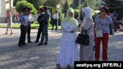 Женщины в одежде по исламским канонам и сотрудники полиции рядом с мечетью в Алматы. Иллюстративное фото.