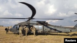 U.S. soldiers ride in a helicopter at a military base north of Mosul in January 2017.