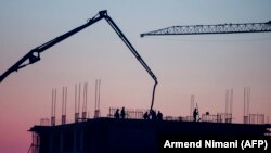 KOSOVO -- Employees are seen working at a construction site of a new project as the sun sets in Pristina, November 5, 2017