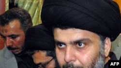 Iraq -- Shi'ite cleric Muqtada al-Sadr surrounded by bodyguards arrives in his stronghold of Najaf, 05Jan2011