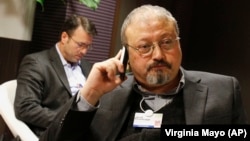 Saudi journalist Jamal Khashoggi speaks on his phone at the World Economic Forum in Davos in 2011.