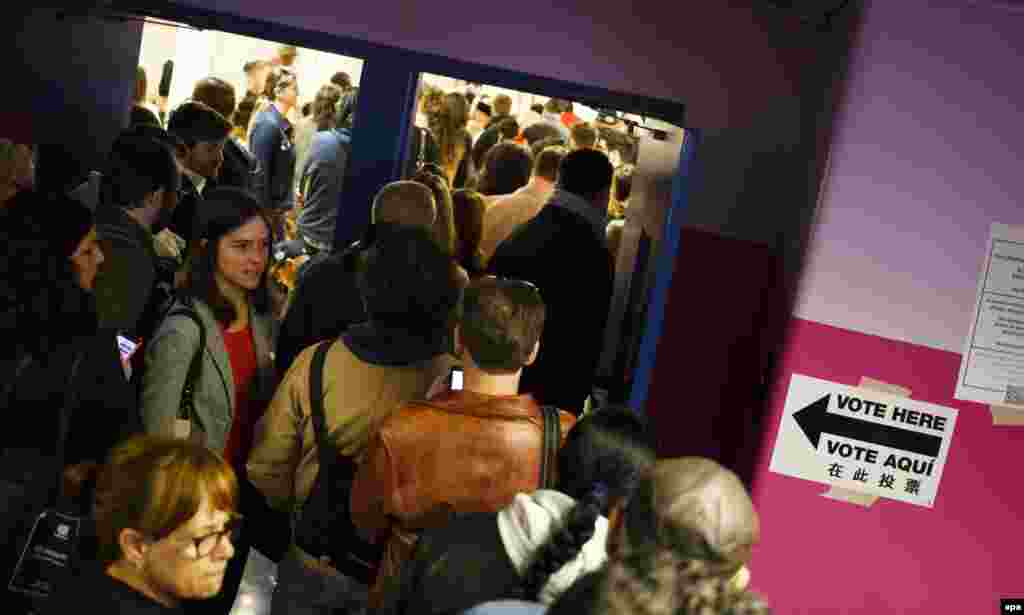 People wait in line at a polling station in an elementary school in Brooklyn, New York.