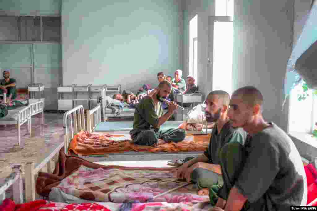 A patient plays a flute in a dormitory of the detoxification ward of the Avicenna Medical Hospital for Drug Treatment in Kabul on October 16.