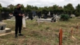 Serbia – Refugee from Iran at the separate part of the Orthodox cemetery near the ‘Sid station’ refugee center (near the Serbia-Croatia border), where refugees and migrants from the Middle East who died trying to cross into Western countries, are buried. 