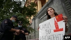 A journalist holds a placard which reads "Foreign agents yourself" near the headquarters of Russia's Federal Security Service (FSB) in Moscow (file photo)