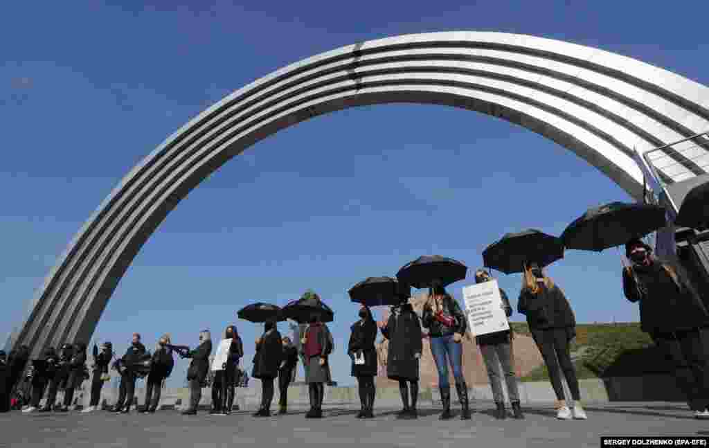 Ukrainian activists attend a Walk For Freedom march dedicated to European Anti-Trafficking Day, near the Friendship of Nations Arch in downtown Kyiv on October 16.