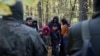 POLAND / BELARUS - A group of Iraqi migrants is surrounded by border guards and police officers after they crossed the Belarusian-Polish border during the ongoing migrant crisis, in Hajnowka, 14OCT2021